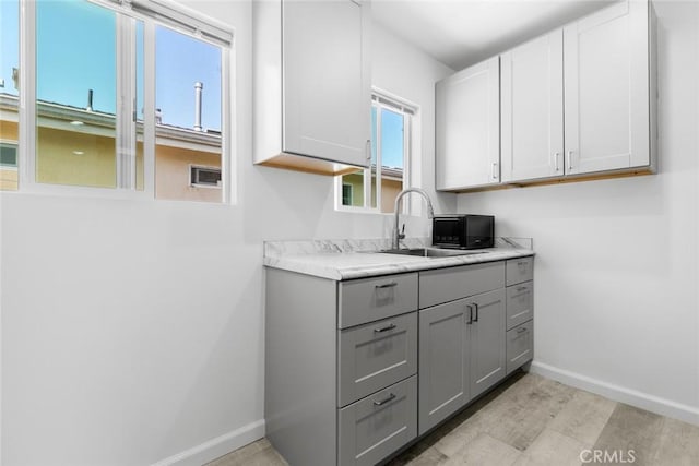 142 S Savannah St, Los Angeles, CA 90033 - laundry area with a sink and baseboards