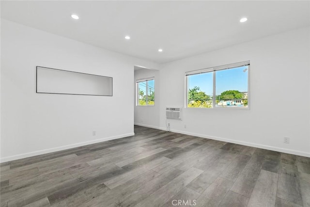 142 S Savannah St, Los Angeles, CA 90033 - empty room with recessed lighting, wood finished floors, a wall unit AC, and baseboards