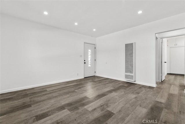 142 S Savannah St, Los Angeles, CA 90033 - spare room featuring a heating unit, dark wood-type flooring, recessed lighting, and baseboards
