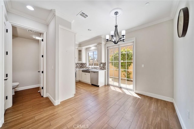 130 Alta St Unit B, Arcadia, CA 91006 - kitchen with stainless steel dishwasher, light wood-style floors, white cabinetry, ornamental molding, and a chandelier
