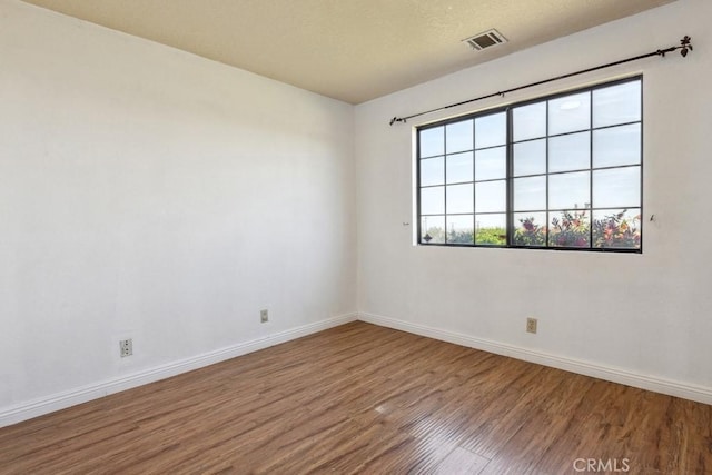 8636 Riggins Rd, Phelan, CA 92371 - empty room with wood finished floors and baseboards
