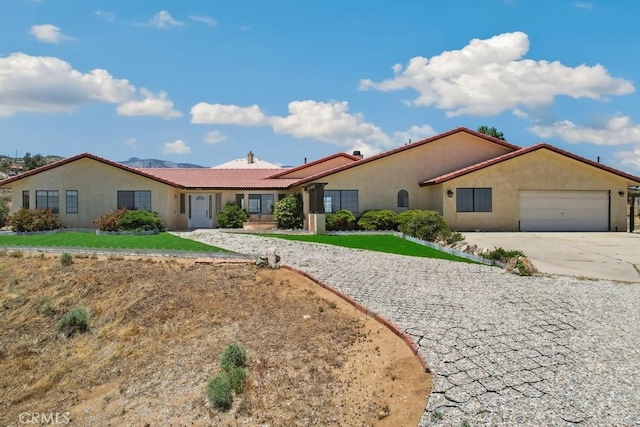8636 Riggins Rd, Phelan, CA 92371 - ranch-style house featuring stucco siding, an attached garage, a tile roof, and driveway
