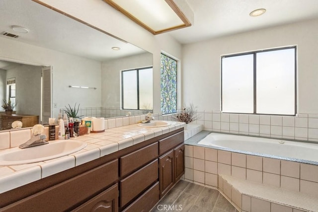 8636 Riggins Rd, Phelan, CA 92371 - bathroom with double vanity, a garden tub, and recessed lighting