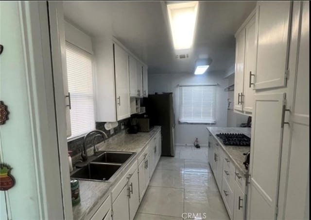 18763 Sunburst St, Northridge, CA 91324 - kitchen featuring a sink, white cabinetry, light countertops, and black gas stovetop