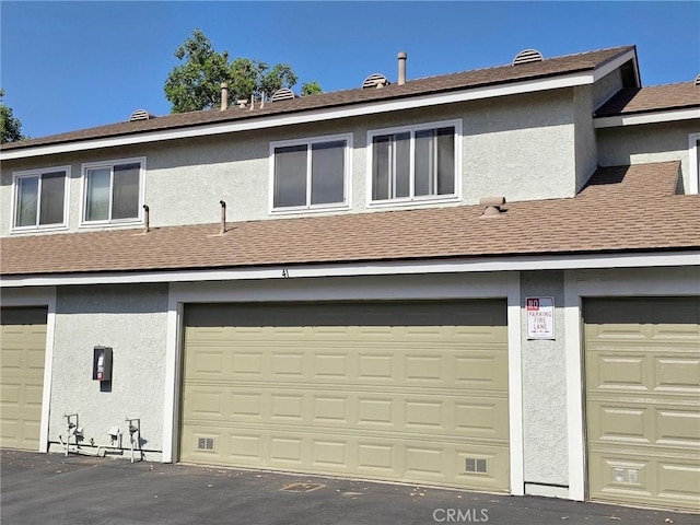 1650 S Campus Ave Unit 41, Ontario, CA 91761 - rear view of property featuring stucco siding and a shingled roof
