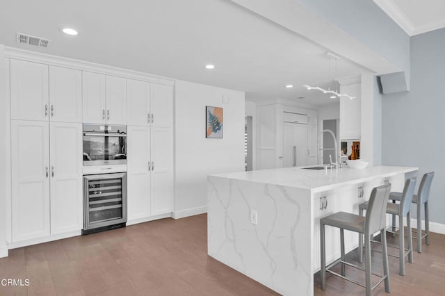 320 Starlane Dr, La Canada Flintridge, CA 91011 - kitchen with a sink, wine cooler, oven, wood finished floors, and recessed lighting