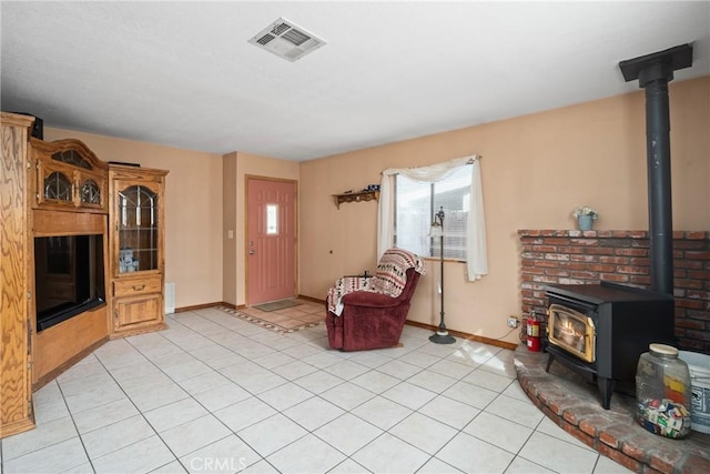 42868 Ranch Club Rd, Lake Elizabeth, CA 93532 - living room with a wood stove, baseboards, and light tile patterned floors