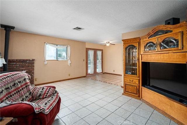 42868 Ranch Club Rd, Lake Elizabeth, CA 93532 - living room featuring light tile patterned flooring, french doors, a ceiling fan, baseboards, and a textured ceiling