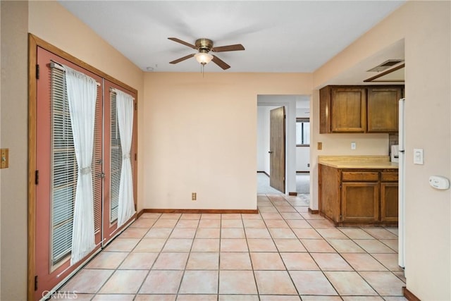 42868 Ranch Club Rd, Lake Elizabeth, CA 93532 - kitchen with a ceiling fan, brown cabinetry, light countertops, and baseboards