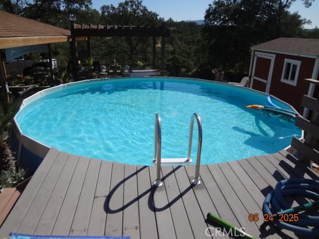 5475 Wilkinson Ave, Clearlake, CA 95422 - swimming pool featuring an outdoor structure and a deck