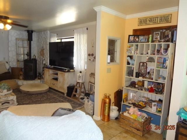 5475 Wilkinson Ave, Clearlake, CA 95422 - living area featuring ceiling fan, a wood stove, ornamental molding, and tile patterned flooring