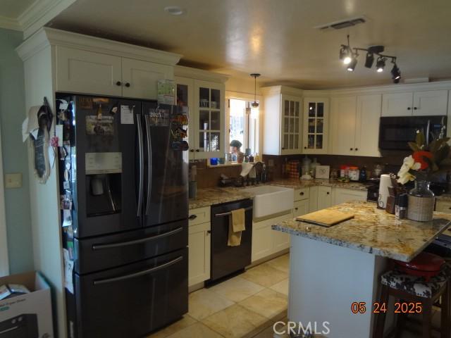 5475 Wilkinson Ave, Clearlake, CA 95422 - kitchen with black appliances, glass insert cabinets, white cabinetry, light stone counters, and crown molding