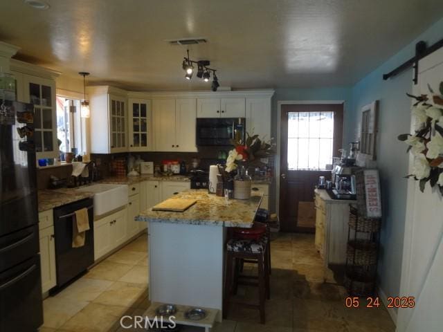 5475 Wilkinson Ave, Clearlake, CA 95422 - kitchen featuring black appliances, glass insert cabinets, a sink, light stone countertops, and white cabinets