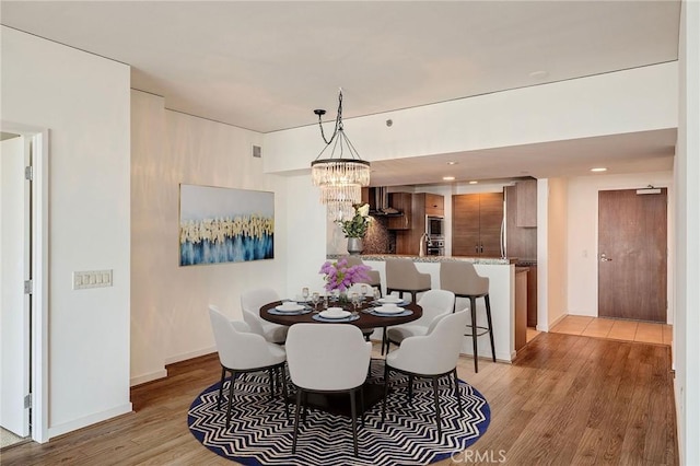 13650 Marina Pointe Dr Unit 908, Marina Del Rey, CA 90292 - dining space featuring light wood-type flooring, a chandelier, and baseboards