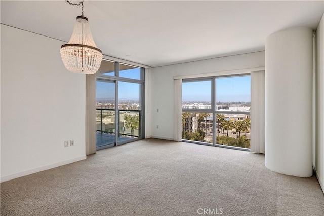13650 Marina Pointe Dr Unit 908, Marina Del Rey, CA 90292 - unfurnished room with carpet, healthy amount of natural light, a chandelier, and floor to ceiling windows