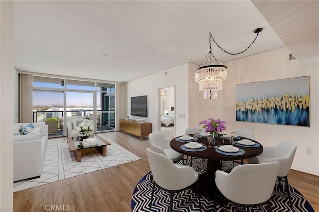 13650 Marina Pointe Dr Unit 908, Marina Del Rey, CA 90292 - dining area with a chandelier, expansive windows, and wood finished floors