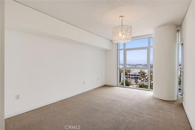 13650 Marina Pointe Dr Unit 908, Marina Del Rey, CA 90292 - carpeted empty room with floor to ceiling windows, a chandelier, and baseboards