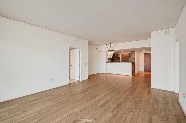 13650 Marina Pointe Dr Unit 908, Marina Del Rey, CA 90292 - unfurnished living room with light wood finished floors and baseboards