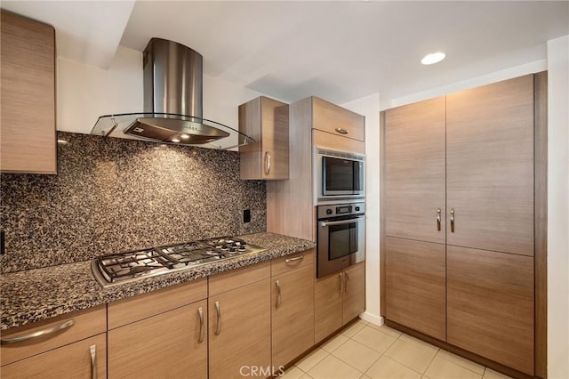 13650 Marina Pointe Dr Unit 908, Marina Del Rey, CA 90292 - kitchen with stainless steel appliances, island range hood, decorative backsplash, light tile patterned floors, and dark stone countertops