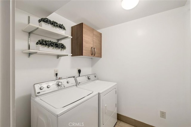 13650 Marina Pointe Dr Unit 908, Marina Del Rey, CA 90292 - washroom featuring cabinet space, washer and dryer, light tile patterned flooring, and baseboards