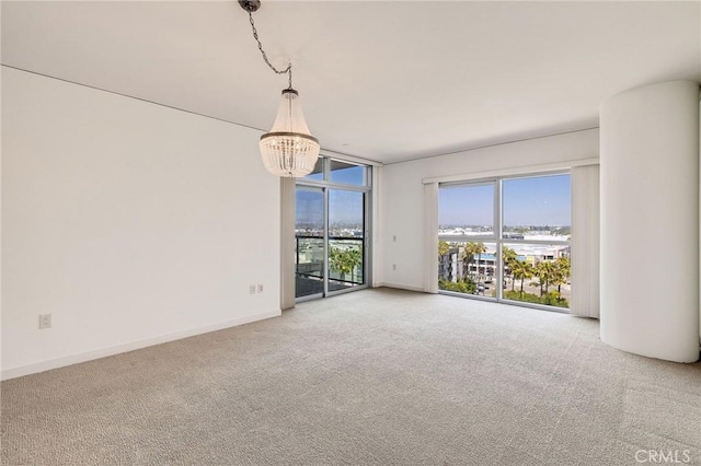 13650 Marina Pointe Dr Unit 908, Marina Del Rey, CA 90292 - carpeted spare room featuring a chandelier, baseboards, and expansive windows