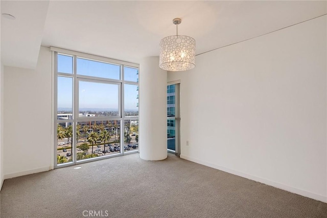 13650 Marina Pointe Dr Unit 908, Marina Del Rey, CA 90292 - spare room with floor to ceiling windows, a chandelier, carpet, and baseboards