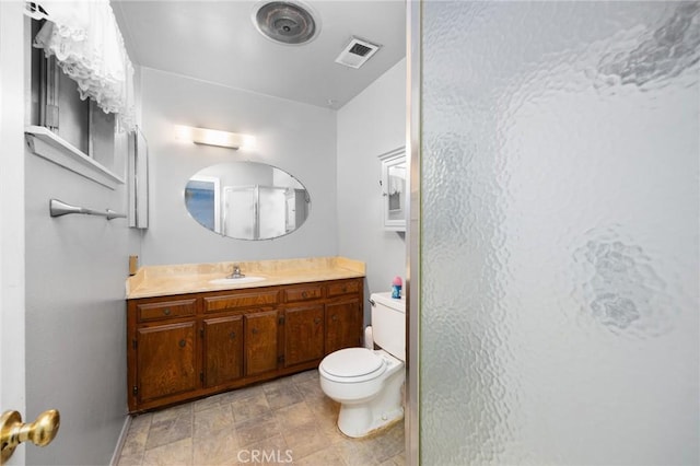 4060 Olive St, Chino, CA 91710 - bathroom with vanity, toilet, a stall shower, stone finish flooring, and baseboards