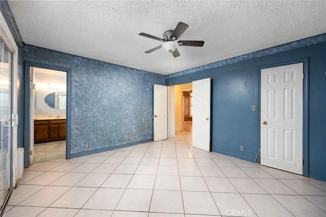 4060 Olive St, Chino, CA 91710 - unfurnished bedroom with a textured ceiling, ceiling fan, baseboards, light tile patterned flooring, and ensuite bathroom