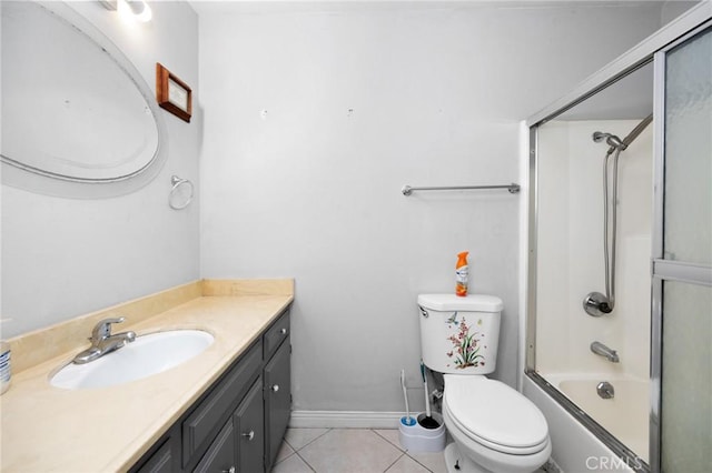 4060 Olive St, Chino, CA 91710 - bathroom featuring vanity, toilet, tile patterned floors, shower / bath combination with glass door, and baseboards