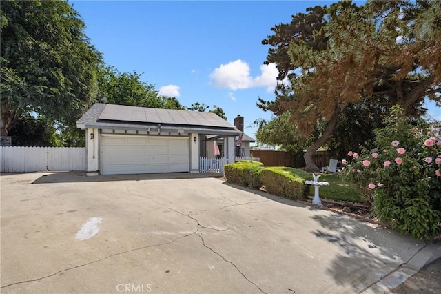 4060 Olive St, Chino, CA 91710 - view of front facade featuring solar panels, a chimney, and concrete driveway