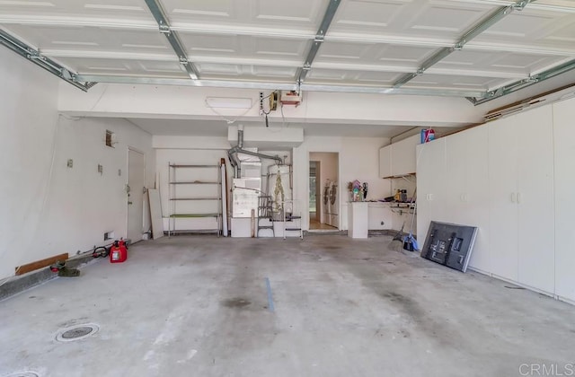 2407 Eastridge Loop, Chula Vista, CA 91915 - garage featuring washer and dryer, heating unit, and a garage door opener