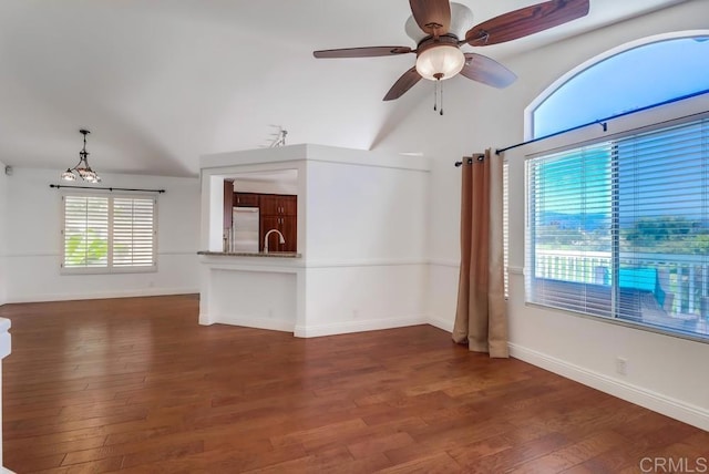 2407 Eastridge Loop, Chula Vista, CA 91915 - unfurnished living room featuring a sink, wood finished floors, vaulted ceiling, a ceiling fan, and baseboards