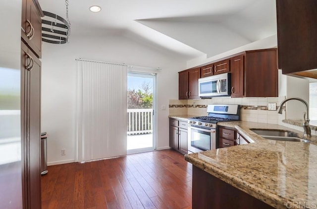 2407 Eastridge Loop, Chula Vista, CA 91915 - kitchen featuring stainless steel appliances, a sink, vaulted ceiling, light stone countertops, and decorative backsplash