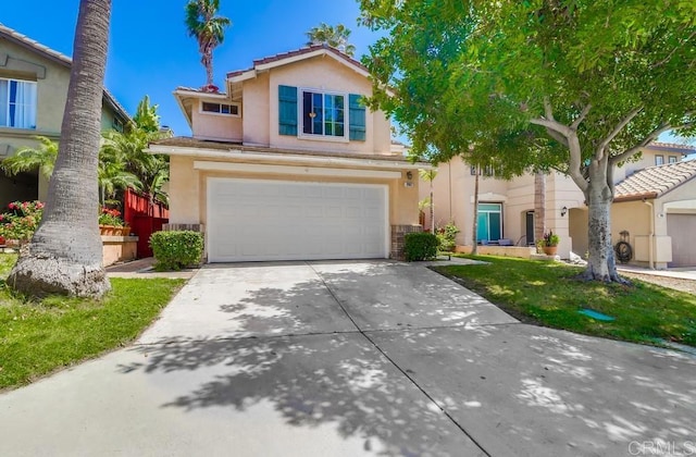 2407 Eastridge Loop, Chula Vista, CA 91915 - view of front of property featuring stucco siding, an attached garage, and concrete driveway