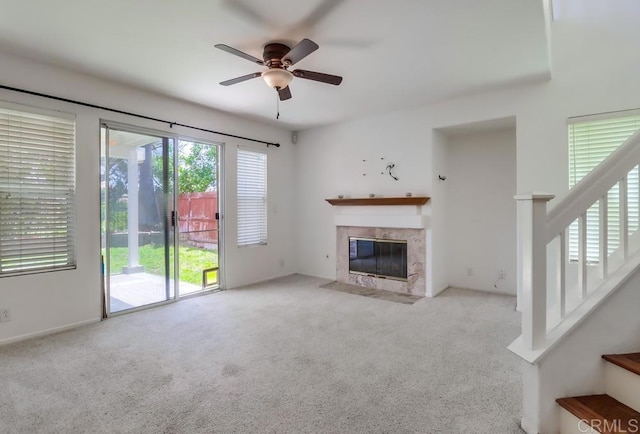 2407 Eastridge Loop, Chula Vista, CA 91915 - unfurnished living room featuring a ceiling fan, a tiled fireplace, carpet floors, and stairway