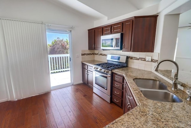 2407 Eastridge Loop, Chula Vista, CA 91915 - kitchen featuring stainless steel appliances, a sink, vaulted ceiling, light stone counters, and tasteful backsplash