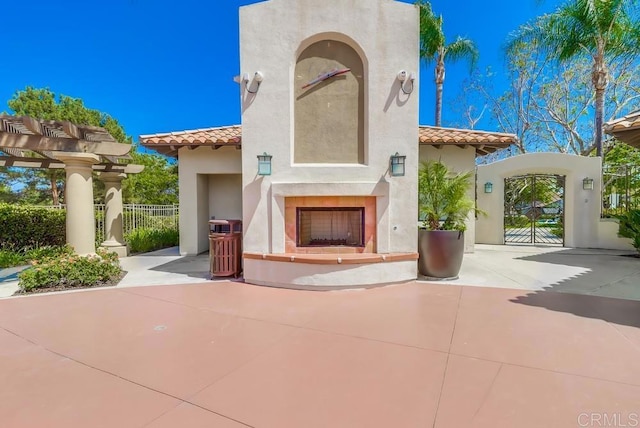 2407 Eastridge Loop, Chula Vista, CA 91915 - view of patio featuring exterior fireplace and a gate