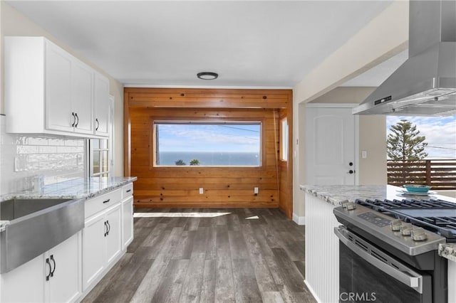 833 Park Ave, Cayucos, CA 93430 - kitchen with wall chimney range hood, stainless steel gas range, light stone countertops, dark wood-type flooring, and plenty of natural light