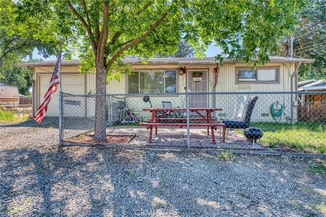 3970 Oakland Ave, Clearlake, CA 95422 - view of front of house with an attached garage, gravel driveway, and board and batten siding