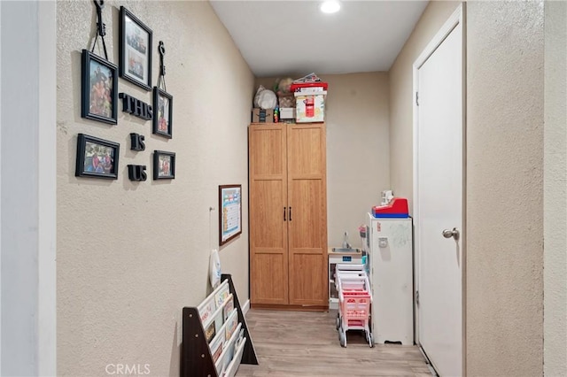 3970 Oakland Ave, Clearlake, CA 95422 - corridor featuring light wood finished floors and a textured wall