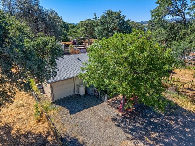 3970 Oakland Ave, Clearlake, CA 95422 - view of front facade with driveway, a garage, and a shingled roof