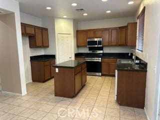44423 Byron St, Lancaster, CA 93535 - kitchen with appliances with stainless steel finishes, dark countertops, a sink, a kitchen island, and recessed lighting