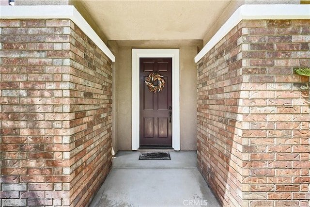 1625 Valley Falls Ave, Redlands, CA 92374 - doorway to property featuring brick siding and stucco siding