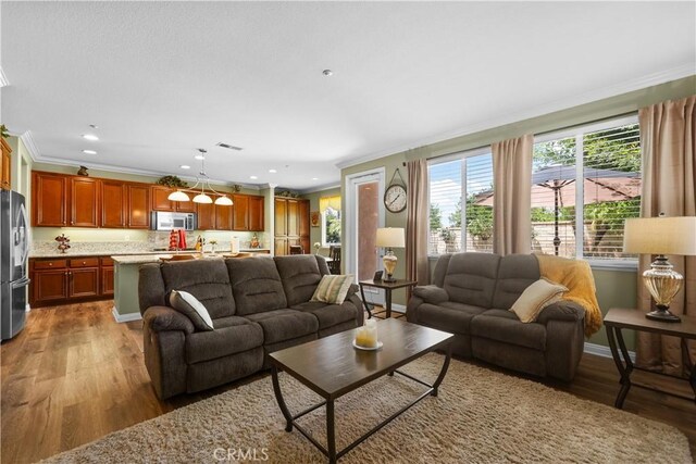 1625 Valley Falls Ave, Redlands, CA 92374 - living area featuring crown molding, wood finished floors, and recessed lighting