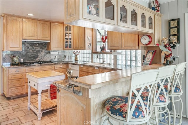 27888 W Shore Rd, Lake Arrowhead, CA 92352 - kitchen with gas stovetop, light brown cabinetry, a sink, decorative backsplash, and glass insert cabinets