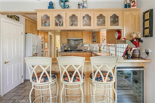 27888 W Shore Rd, Lake Arrowhead, CA 92352 - kitchen with beverage cooler, a sink, gas cooktop, brick flooring, and oven