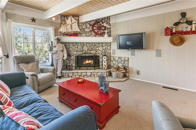 27888 W Shore Rd, Lake Arrowhead, CA 92352 - carpeted living area featuring a stone fireplace, wood ceiling with exposed beams, and baseboards
