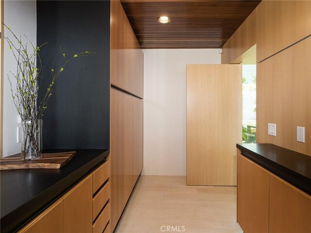 7 Cinchring Rd, Rolling Hills, CA 90274 - kitchen with dark countertops, light wood finished floors, wood ceiling, and modern cabinets