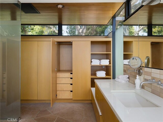 7 Cinchring Rd, Rolling Hills, CA 90274 - bathroom with backsplash, healthy amount of natural light, vanity, and tile patterned floors