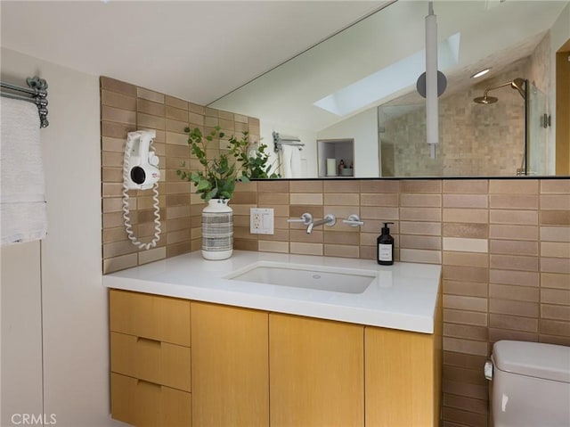 7 Cinchring Rd, Rolling Hills, CA 90274 - bathroom with a skylight, vaulted ceiling, decorative backsplash, vanity, and toilet